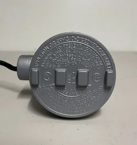 Close-up of the heater's metal electrical termination enclosure and cover markings