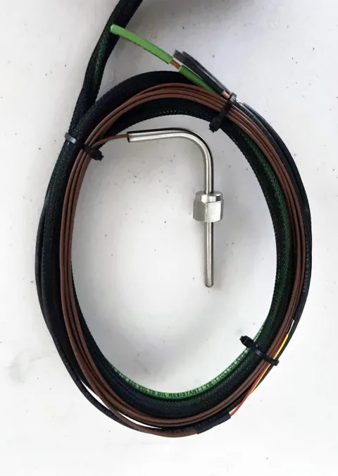 Separate metal temperature probe and coiled lead supplied with the heater