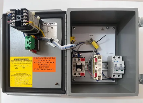 Open control enclosure showing breaker, contactor, solid-state relay and terminal hardware